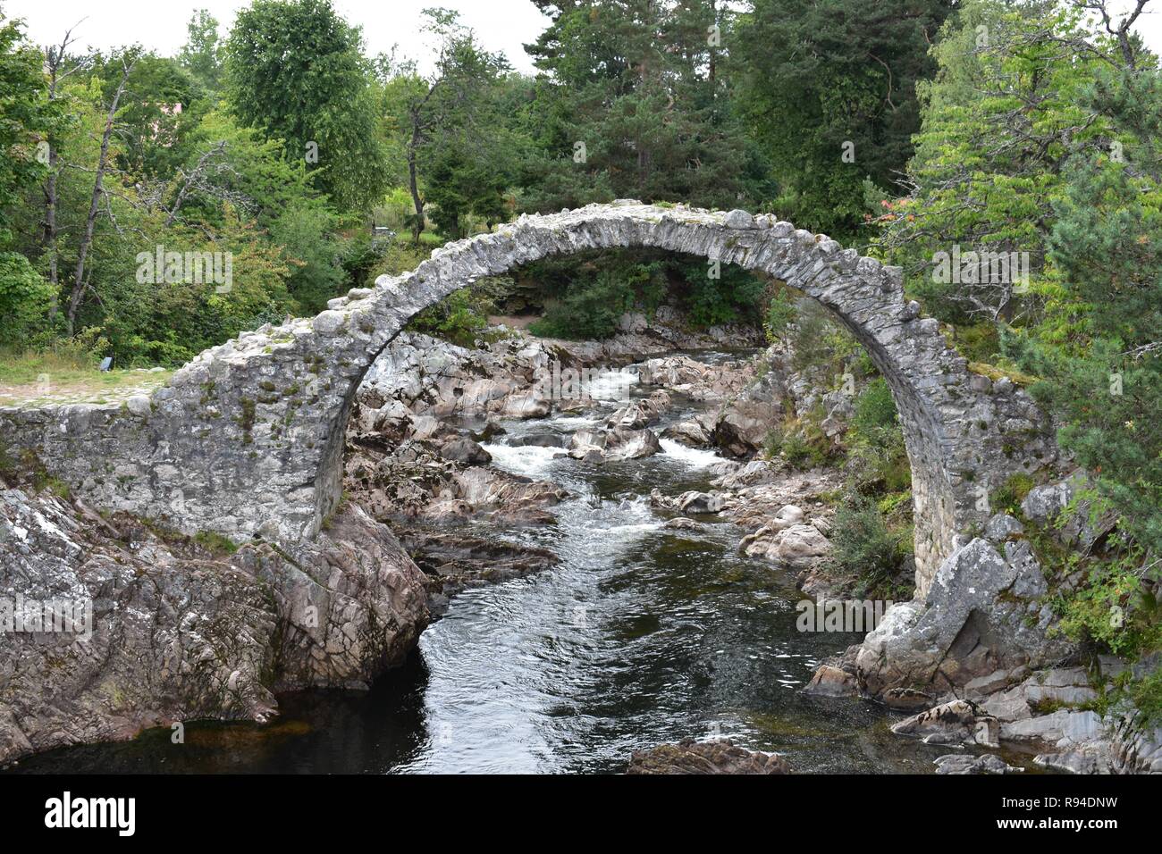 The Old Packhorse Bridge, Carrbridge Village, Badenoch and Strathspey, The Scottish Highlands. Stock Photo