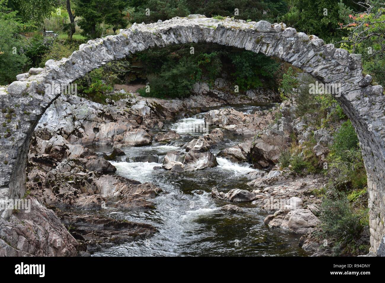 The Old Packhorse Bridge, Carrbridge Village, Badenoch and Strathspey, The Scottish Highlands. Stock Photo