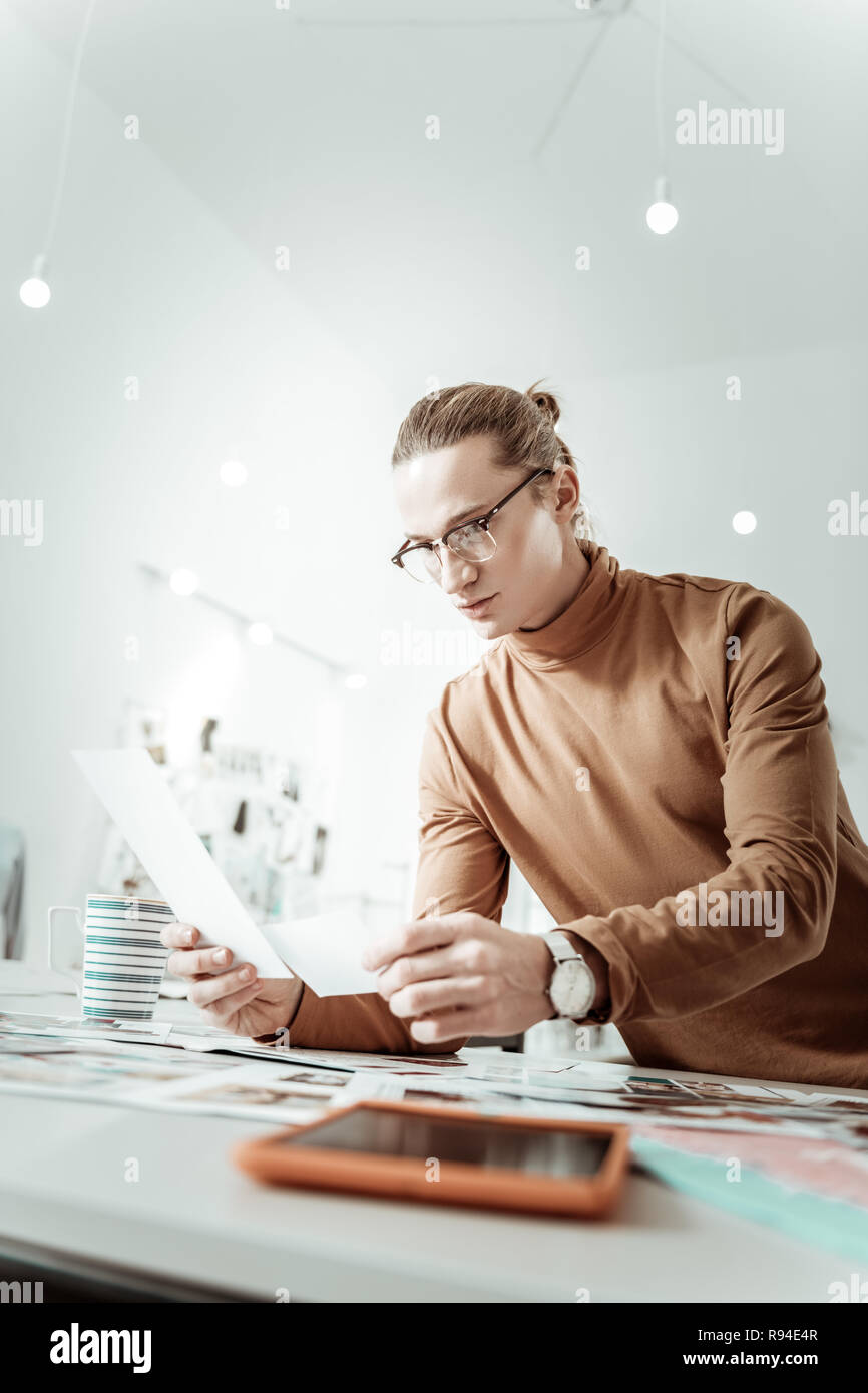 Handsome stylist from generation Y in eyewear looking concentrated Stock Photo