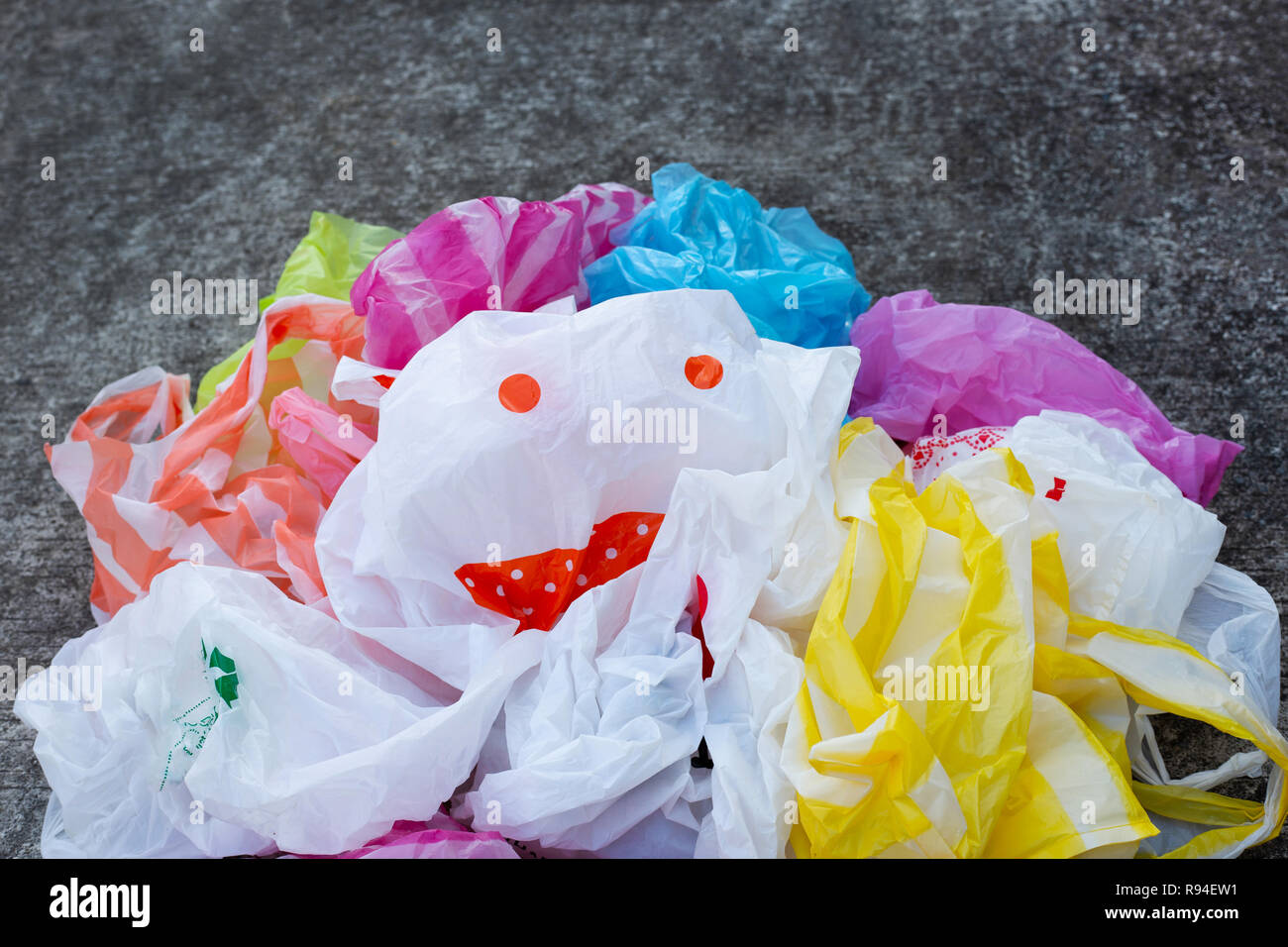 Colorful Plastic Bags On Cement Floor Background Stock Photo
