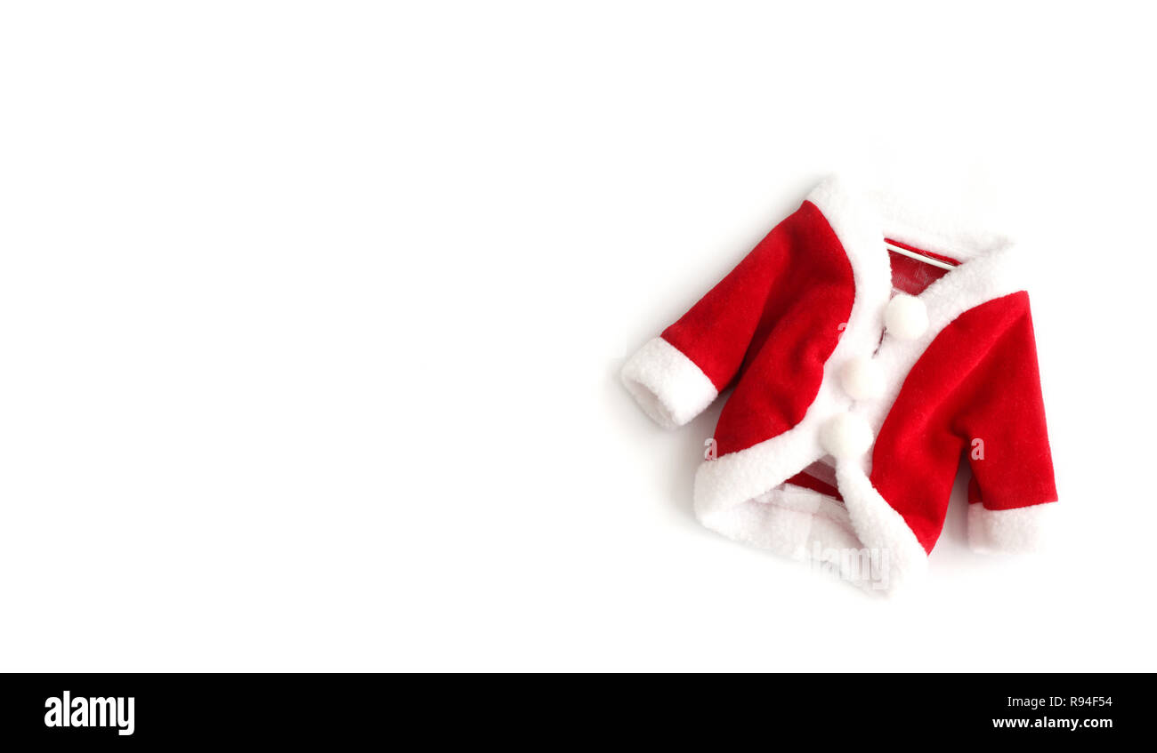 Christmas background Santa Claus (Saint Nicholas) red mini coat suit costume white cuffs flat lay isolated on white background. Concept photo for Merr Stock Photo