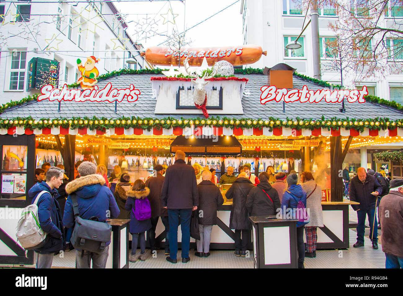 People queuing for bratwurst, fries and other savory snacks at