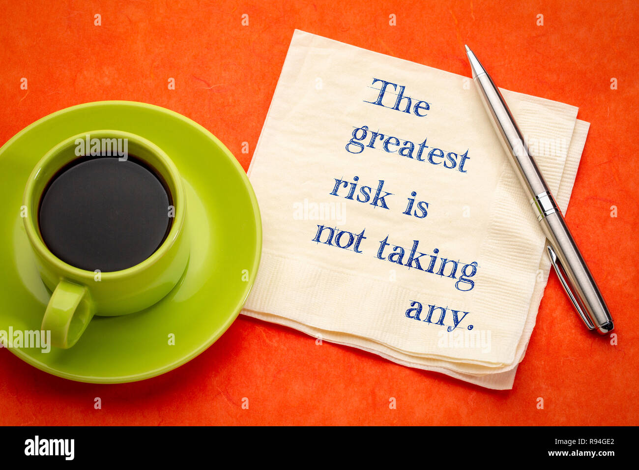 The greatest risk is not taking any - handwriting on a napkin with a cup of coffee Stock Photo