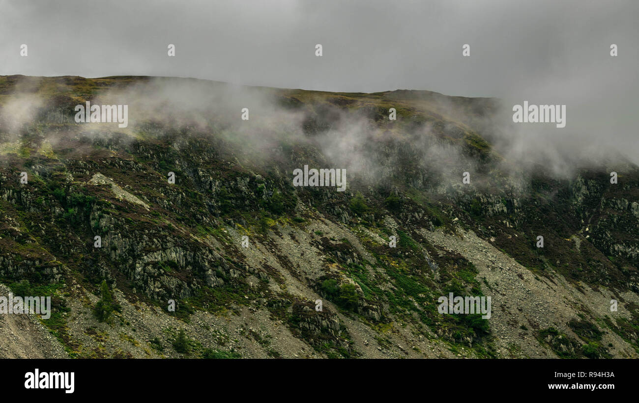 Mist along the ridgeline of the Lake District's mountains in Cumbria, North West England, United Kingdom. Stock Photo