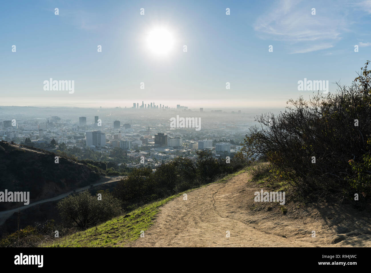 Los Angeles Runyon Canyon Park hiking trail with morning sun, downtown and Hollywood in background. Stock Photo