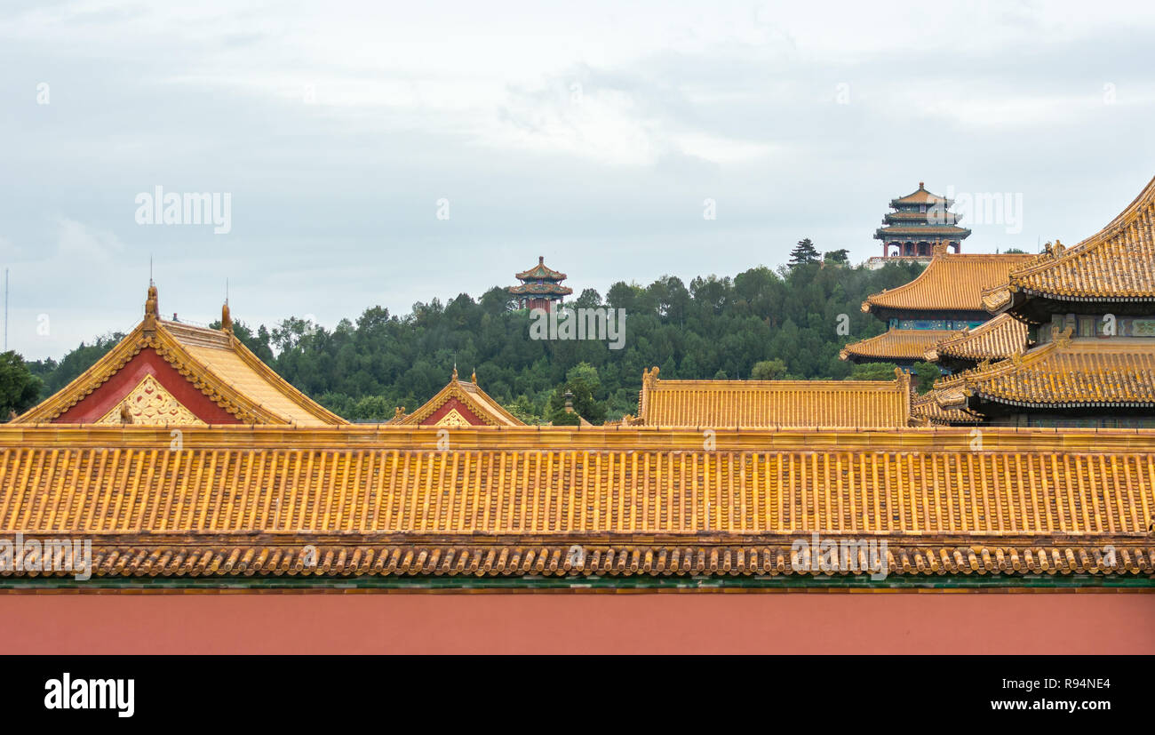 Jingshan Park in background with Wanchun Pavilion on top of Prospect Hill, Forbidden City rooftops in foreground, Beijing, China Stock Photo