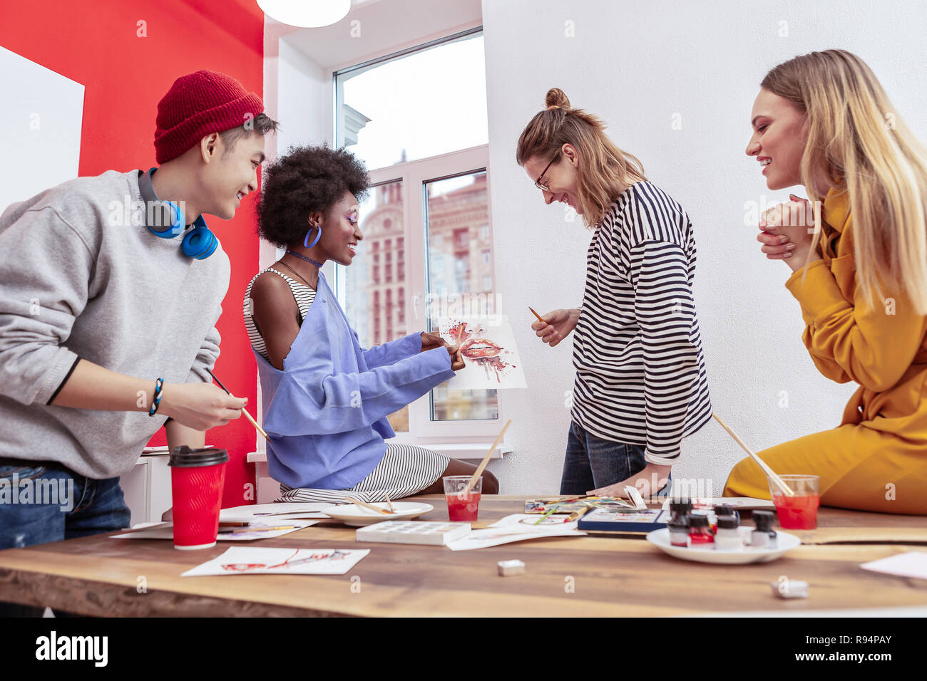 Four students of fashion department having active discussion Stock Photo Alamy