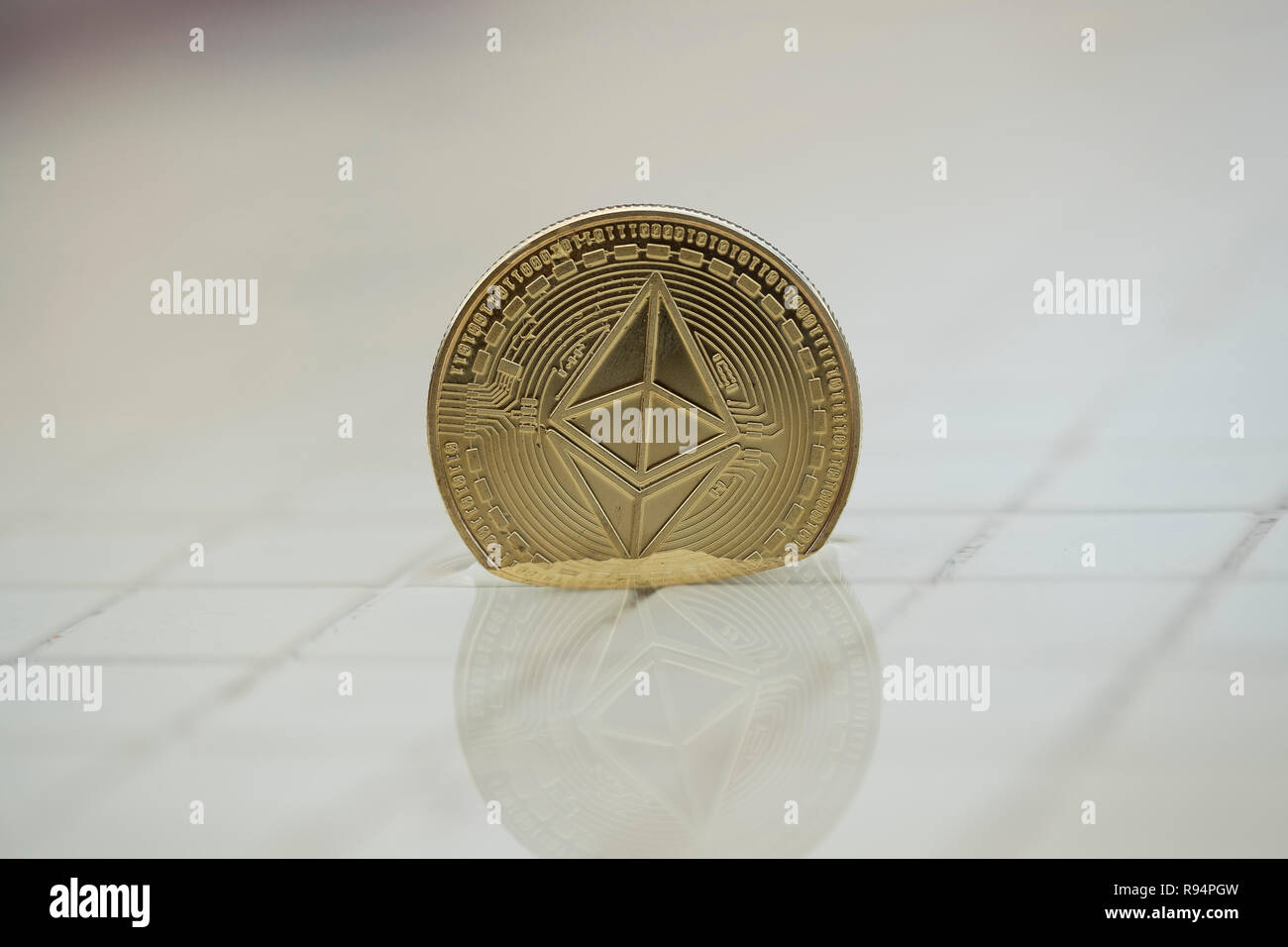 Ethereum Classic cryptocurrency physical coin placed on the side of the pool Stock Photo