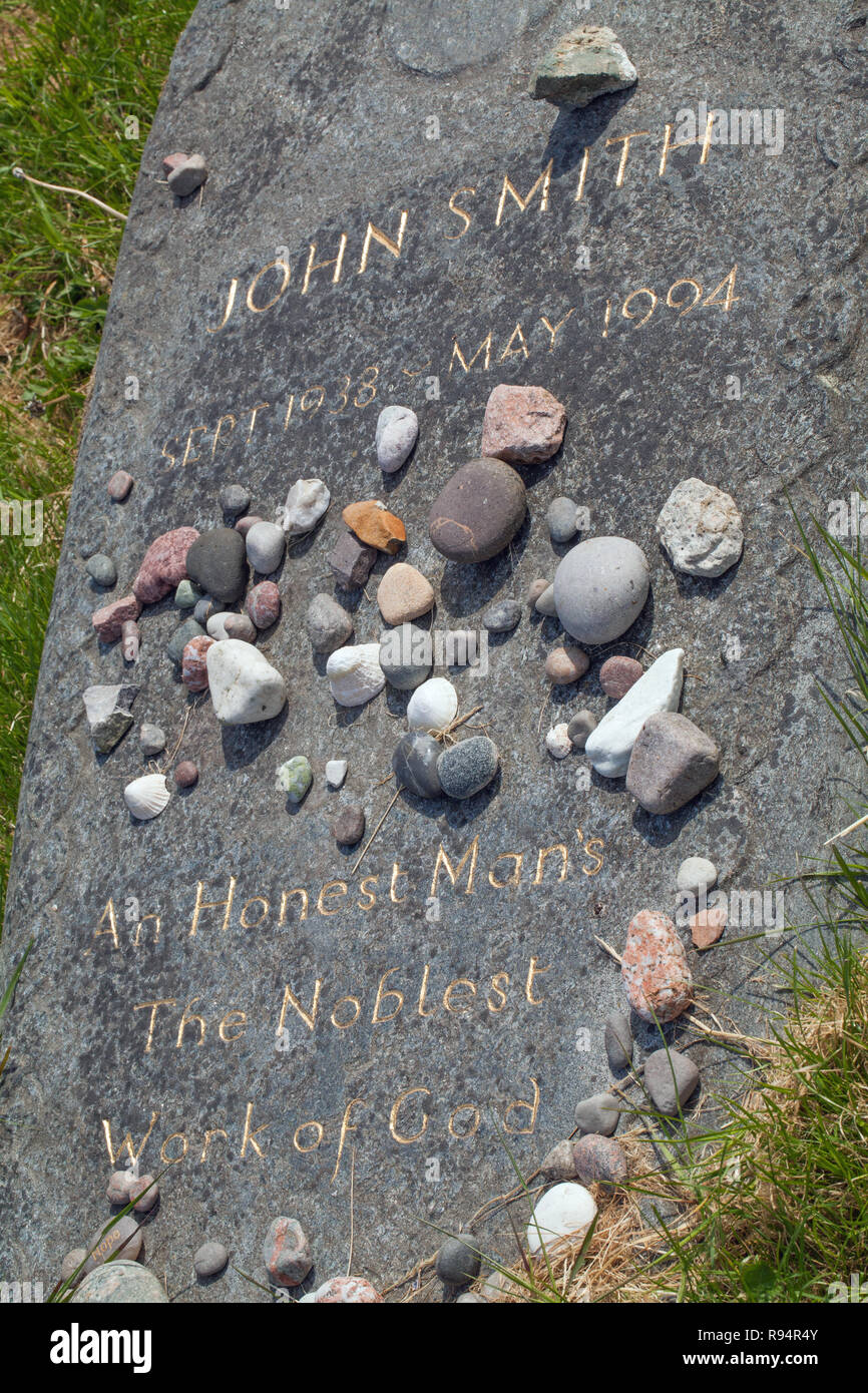 Grave Memorial Stone engraved with the words,” JOHN SMITH, Sept.1938 - MAY 1994,  An Honest Man’s The Noblest Work of God.”  Pebbles placed by visiting admirers of the late politician. Abbey graveyard. The Isle of Iona. The Inner Hebrides. Westcoast Scotland. Stock Photo