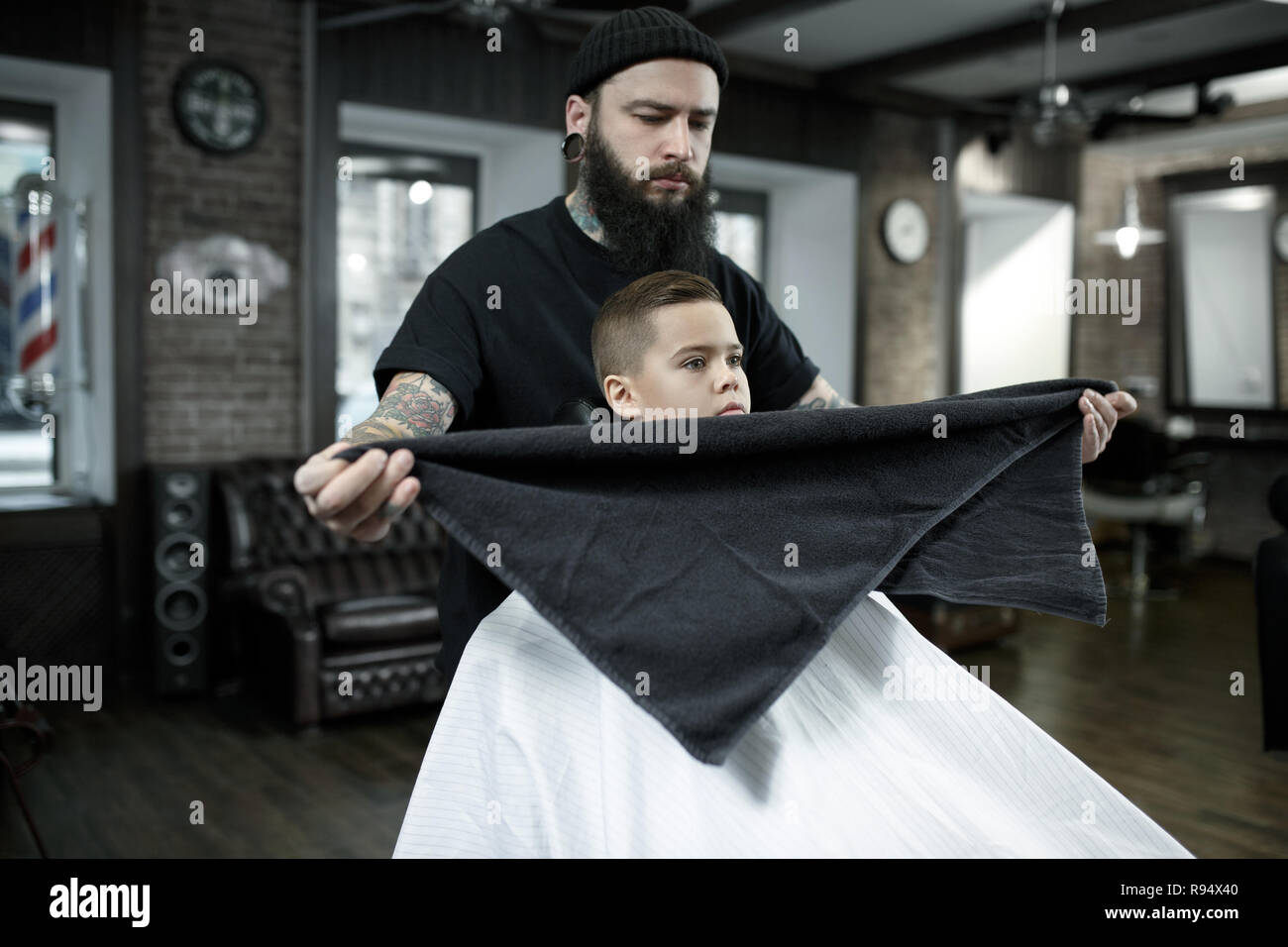 Children Hairdresser Cutting Little Boy Against A Dark