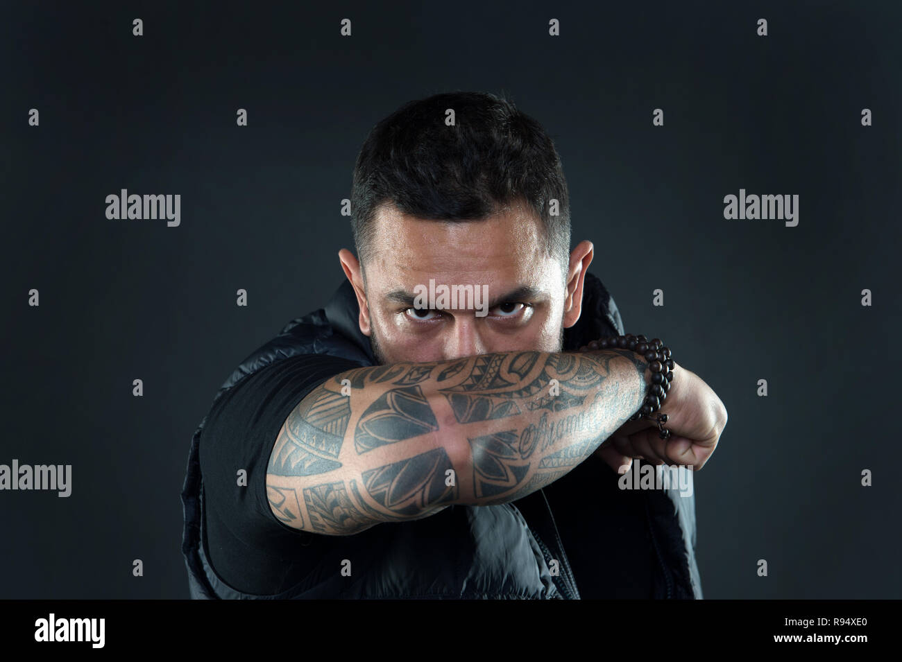 Do tattoos hide lack of masculinity. Man brutal guy cover face with ...