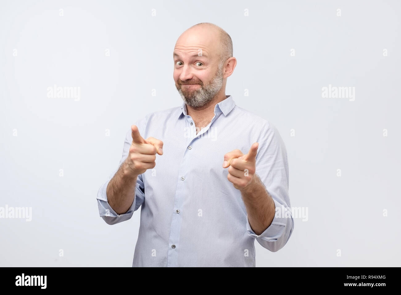 Portrait of happy mature man pointing at you Stock Photo