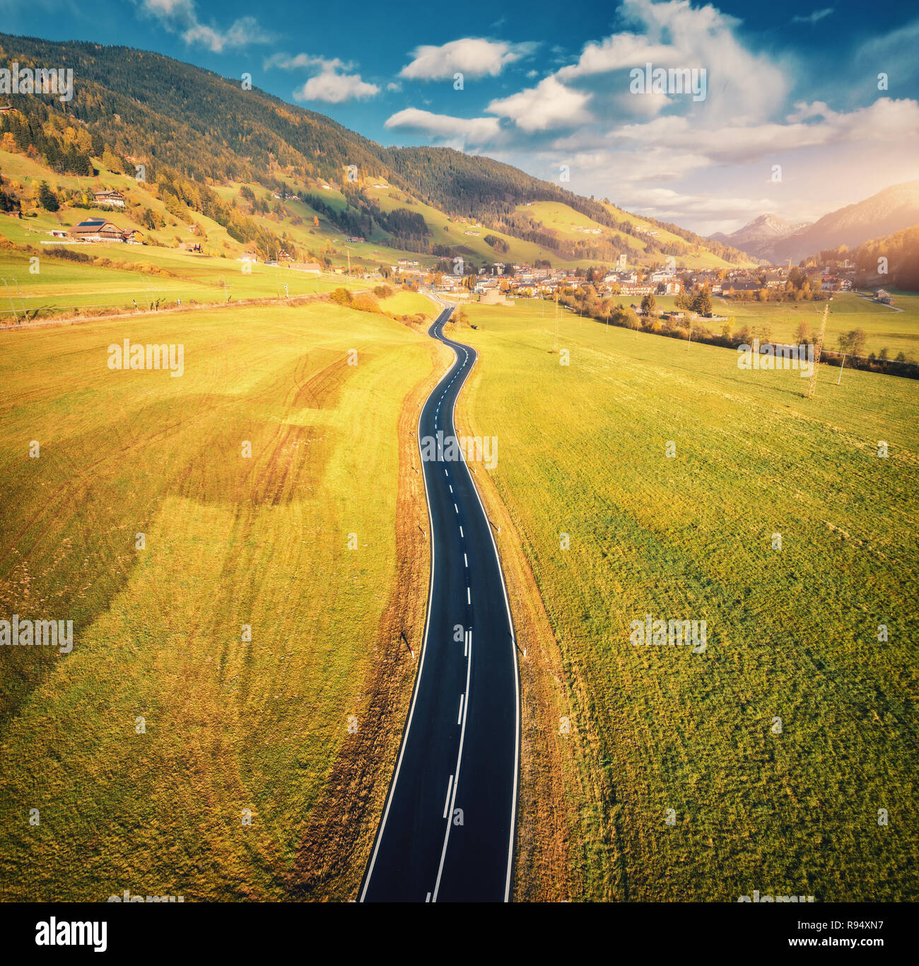 Aerial view of the road in mountain valley at sunset in Dolomites ...