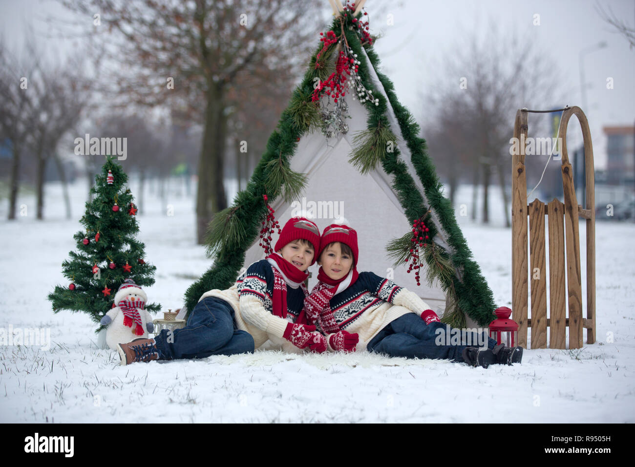 Happy Family With Kids Having Fun Outdoor In The Snow On