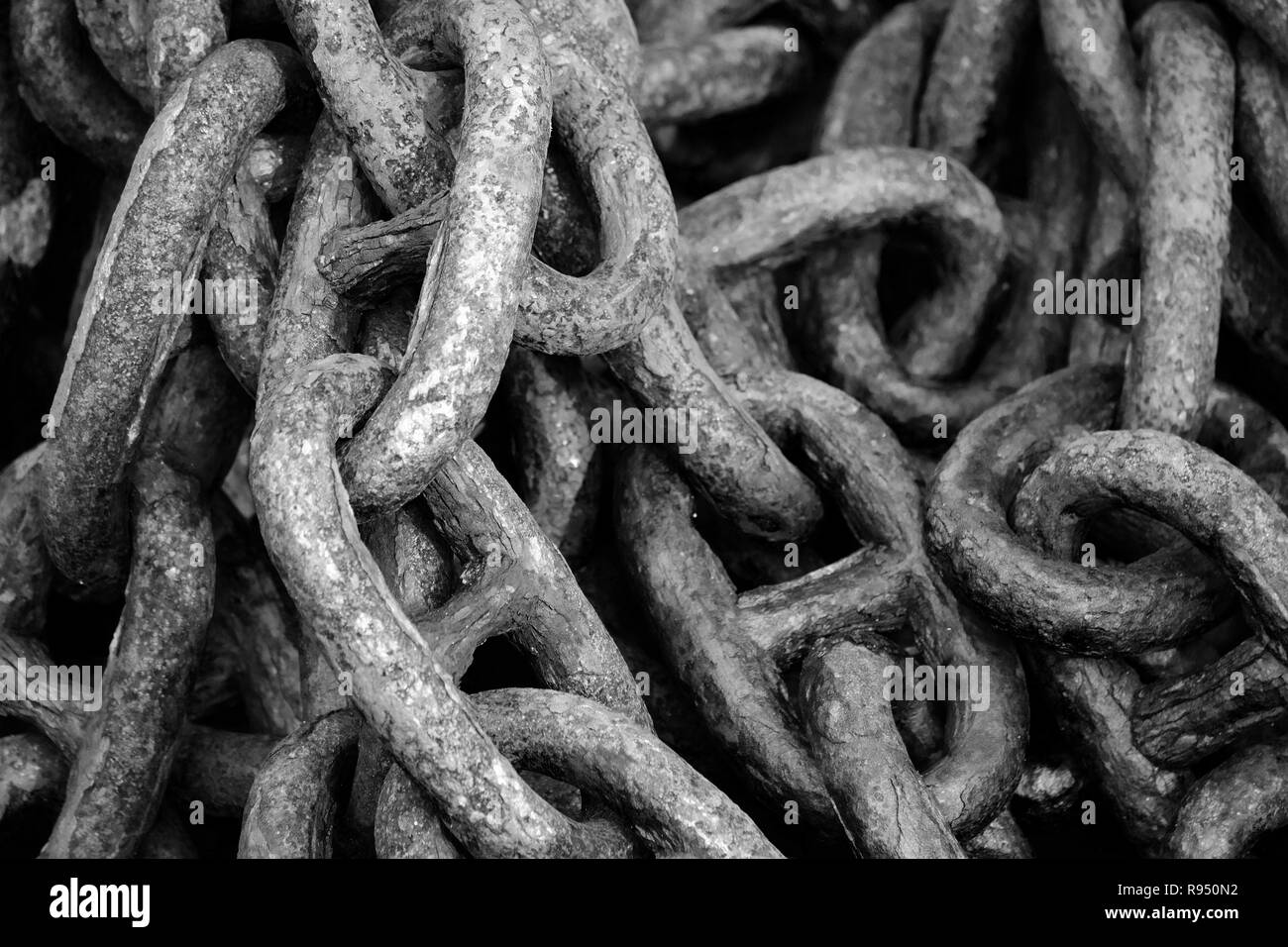 Old rusty anchor chain, black and white, scroll, chain links. Stock Photo