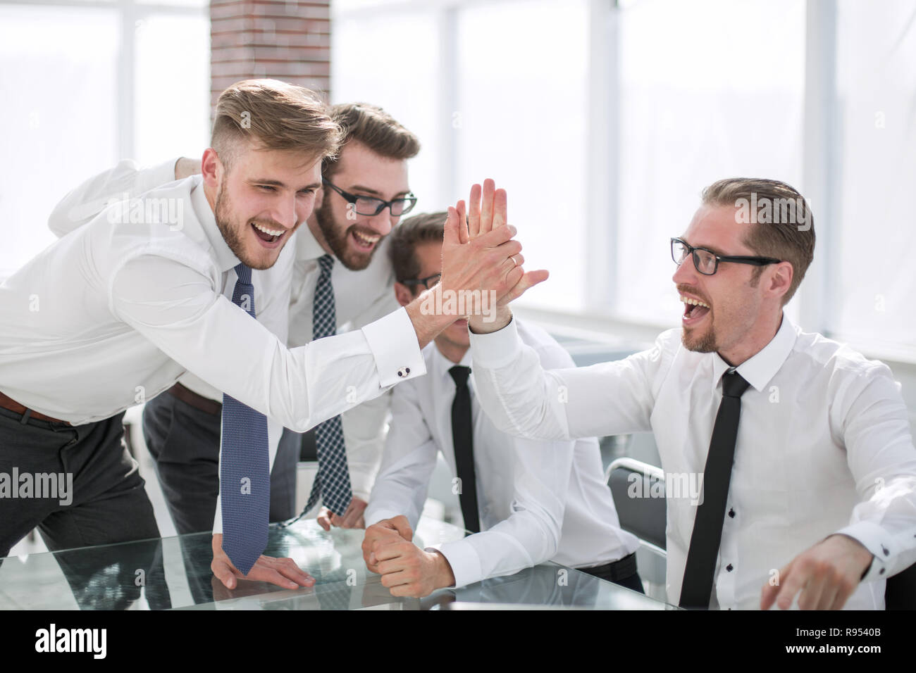 employees giving each other a high five Stock Photo - Alamy