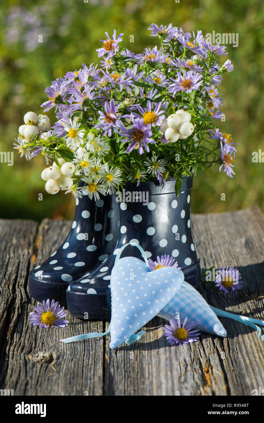 Rubber boots with flowers and hearts Stock Photo - Alamy