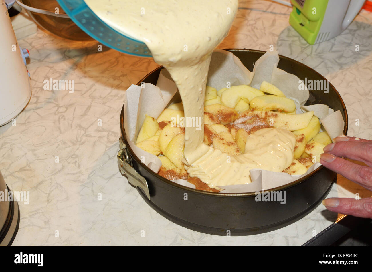 Pouring the dough into a metal mold.It will bake a cake in the oven gas
