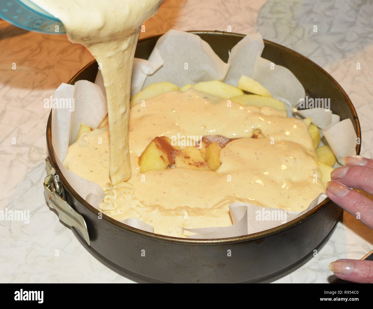 Pouring the dough into a metal mold.It will bake a cake in the oven gas stove Stock Photo Alamy