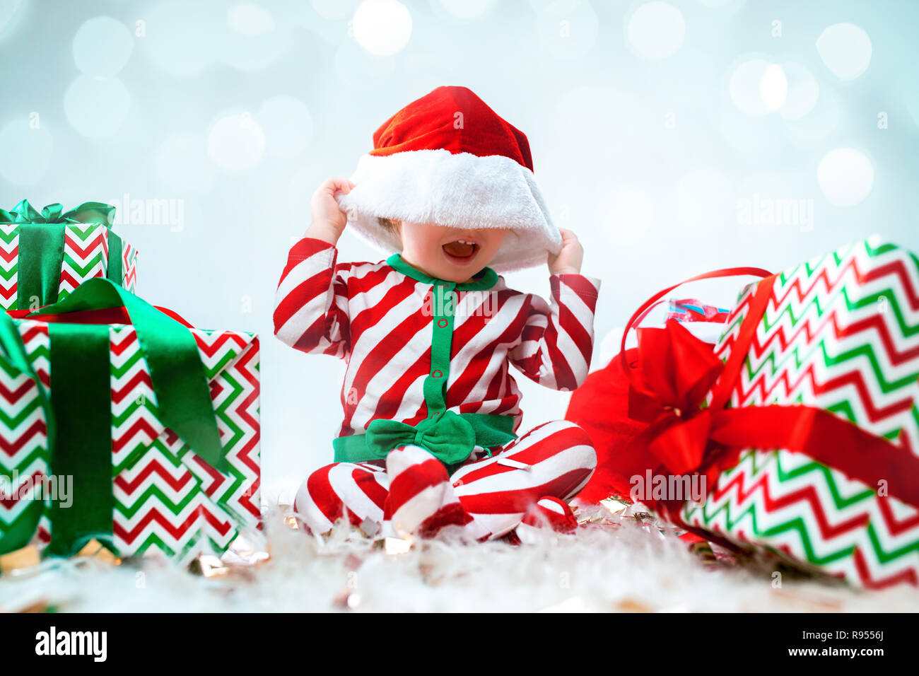 Cute Baby Girl 1 Year Old Wearing Santa Hat Posing Over Christmas