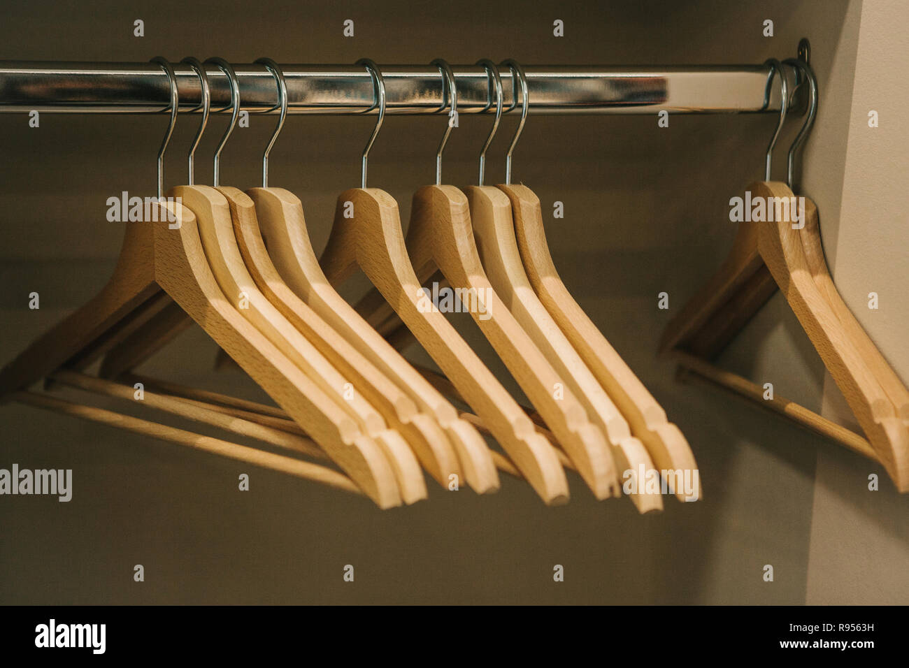 Empty hangers hang in a row in the closet. Stock Photo