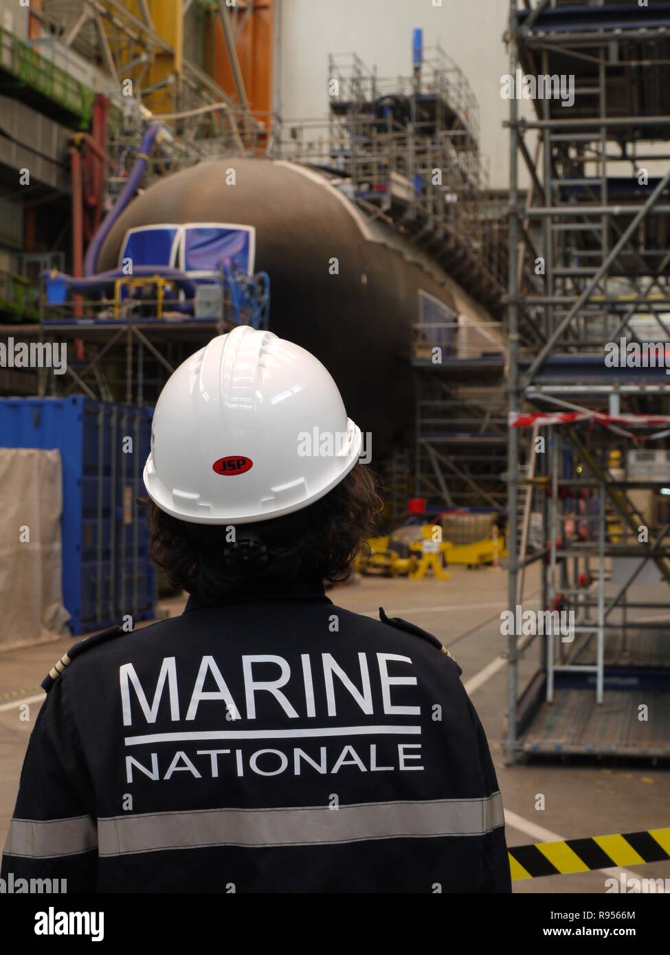 An officer of french army is looking at new submarine Barracuda in french plant of Cherbourg, France Stock Photo