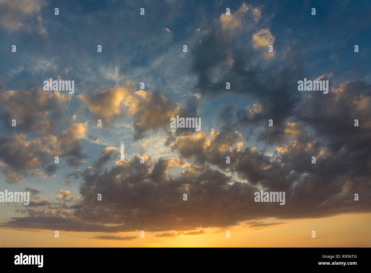 View of massive big Clouds on a colorful Sky. Stock Photo