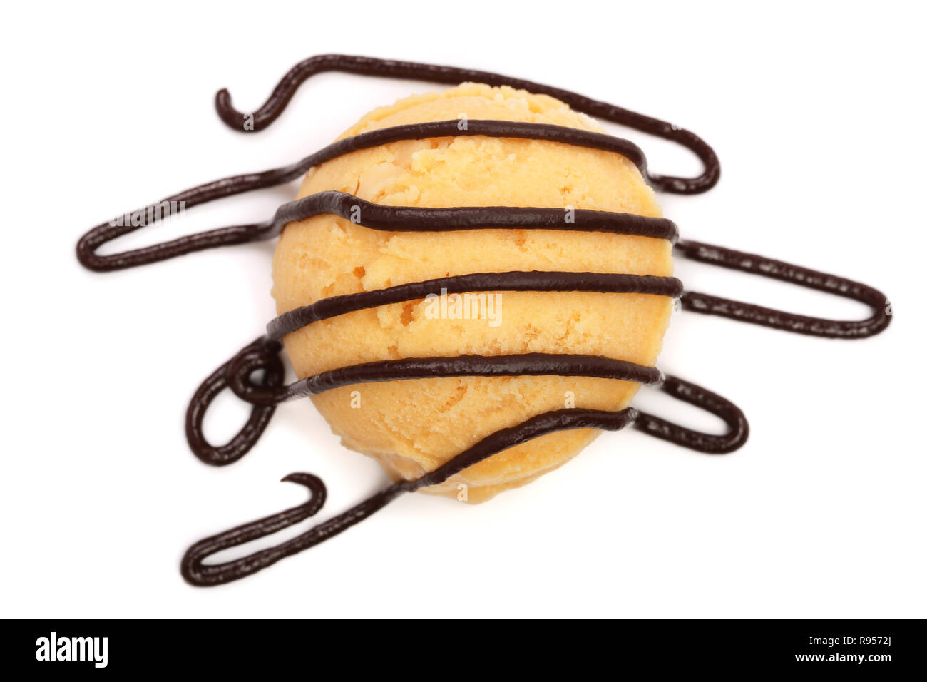 Yellow ice cream with melted chocolate top view isolated on white background Stock Photo