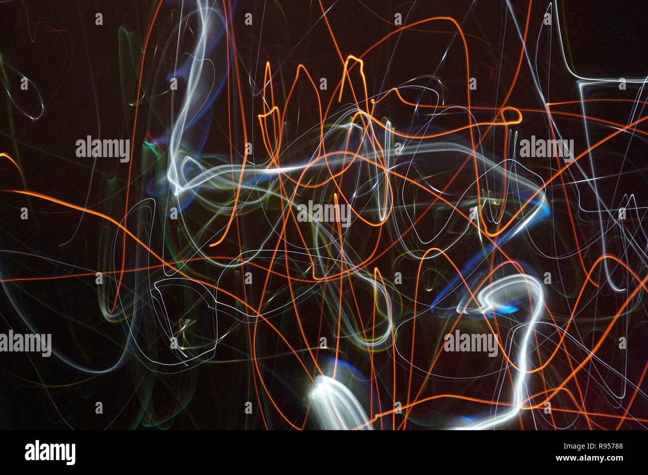 Illuminated light trails on a black background Stock Photo - Alamy