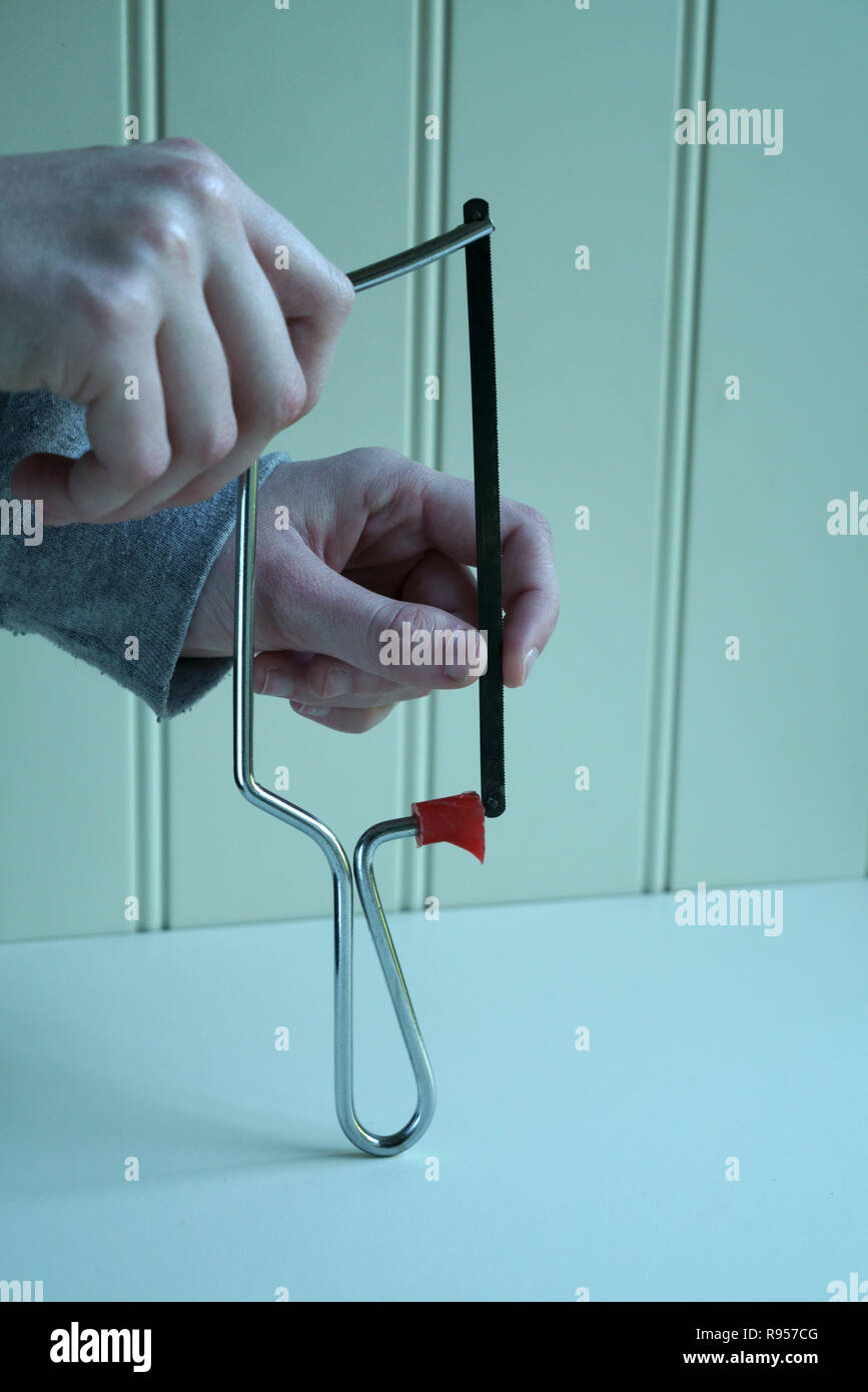 Fitting the blade to a Junior hacksaw Stock Photo Alamy