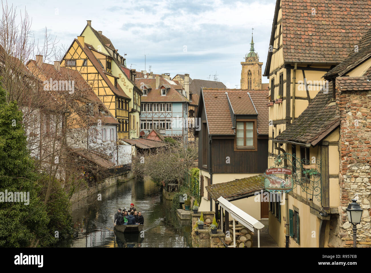 COLMAR, FRANCE - APRIL 2, 2018: Tourists enjoying beautiful cruise on water canal in Little Venice quarter in Colmar, France during Easter 2018 Stock Photo