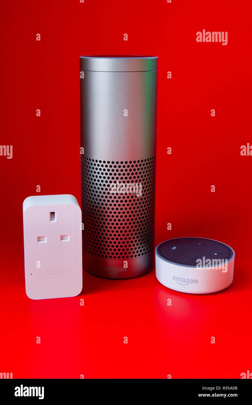 Amazon Echo, Echo Dot and Smart Plug on a red background Stock Photo