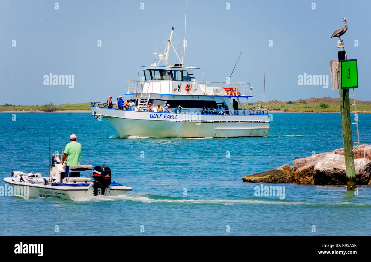 A fisherman watches as the Gulf Eagle, a deep sea fishing charter boat,  returns to dock at Port Aransas Municipal Boat Harbor in Port Aransas,  Texas Stock Photo - Alamy