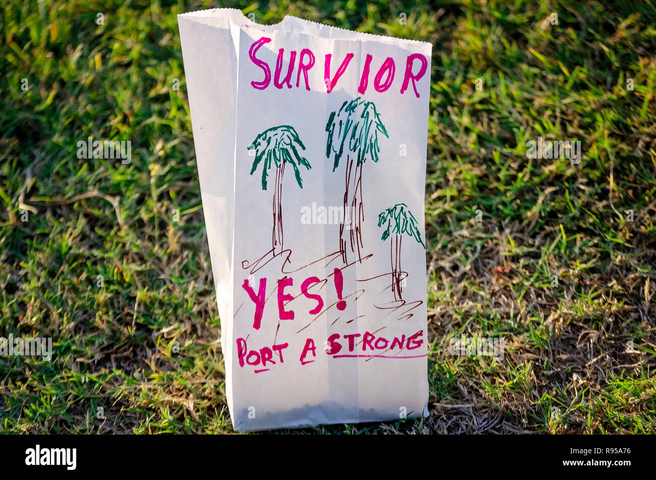 A paper bag containing an electronic votive candle sits in the grass, Aug. 25, 2018, at Roberts Point in Port Aransas, Texas. Stock Photo