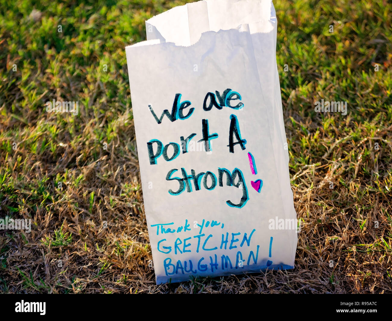 A paper bag containing an electronic votive candle sits in the grass, Aug. 25, 2018, at Roberts Point in Port Aransas, Texas. Stock Photo