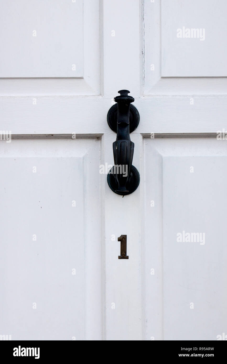 The house number 1 on a white painted door in Hertfordshire. Stock Photo