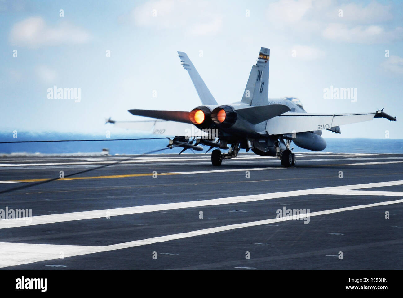 An F/A-18C Hornet assigned to the 'Death Rattlers' of Marine Strike Fighter Squadron Three Two Three (VMFA-323) successfully lands on the flight deck of the Nimitz-class aircraft carrier USS John C. Stennis (CVN 74).  U.S. Navy photo by Mass Communication Specialist 3rd Class Ron Reeves Stock Photo