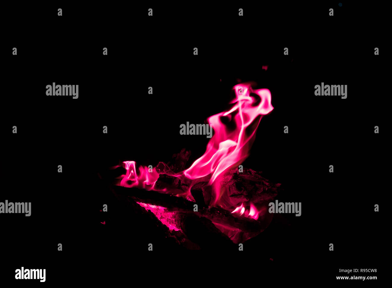 red flames in bonfire on black background - Stock Photo