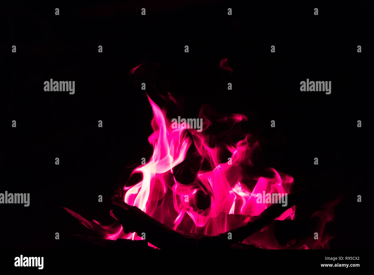 red flames in bonfire on black background - Stock Photo