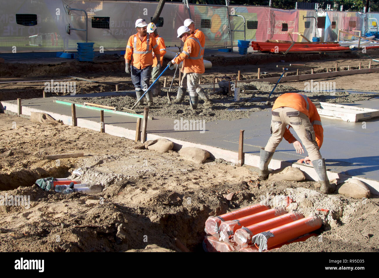 Concrete workers pouring concrete in Scott Street to build the