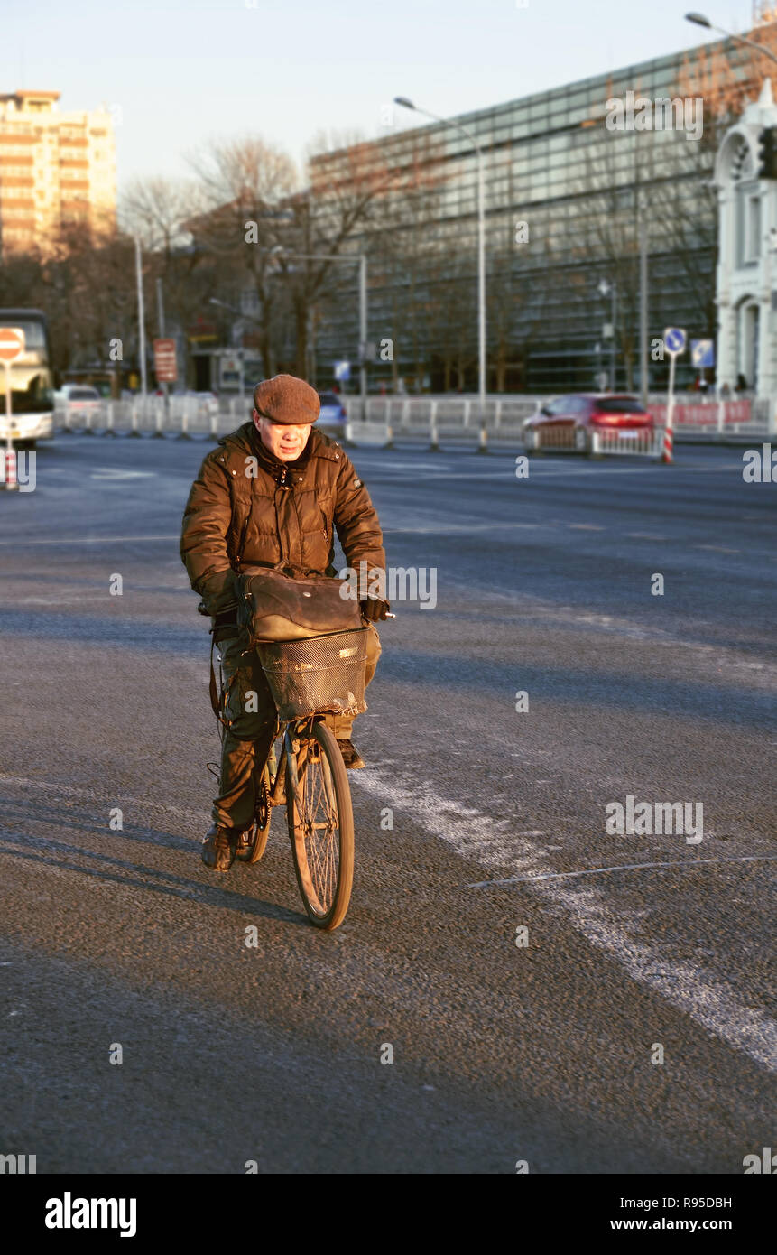 Chinese man riding his bicycle on the street of Beijing Stock Photo