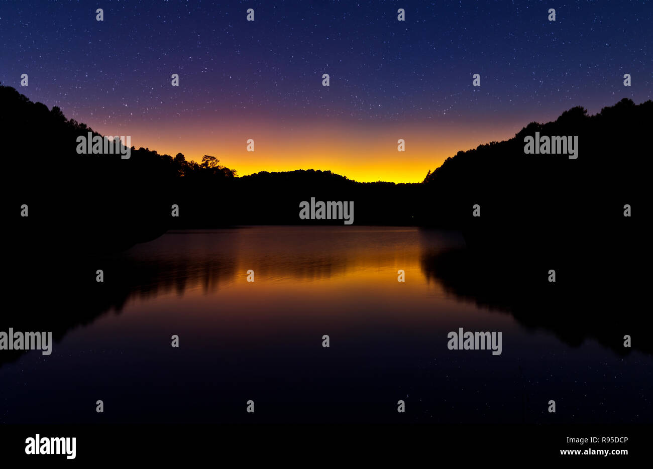 early morning light with the silhouette of the mountain and reflection on the water at Pang Ung Forestry  Plantations,Maehongson, North of Thailand Stock Photo