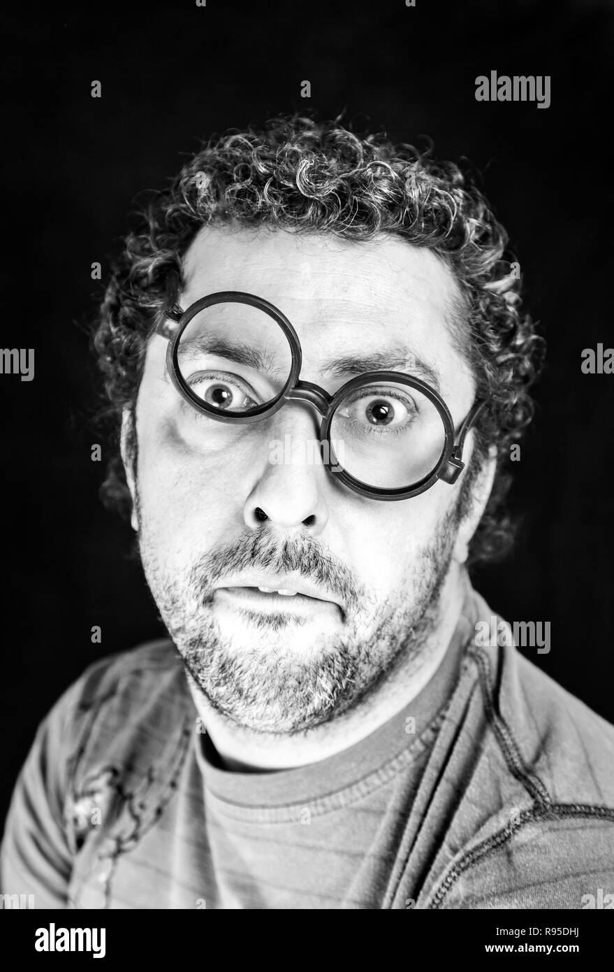 Adult man with crooked glasses detail of a person with curly hair fun and surprise Stock Photo Alamy