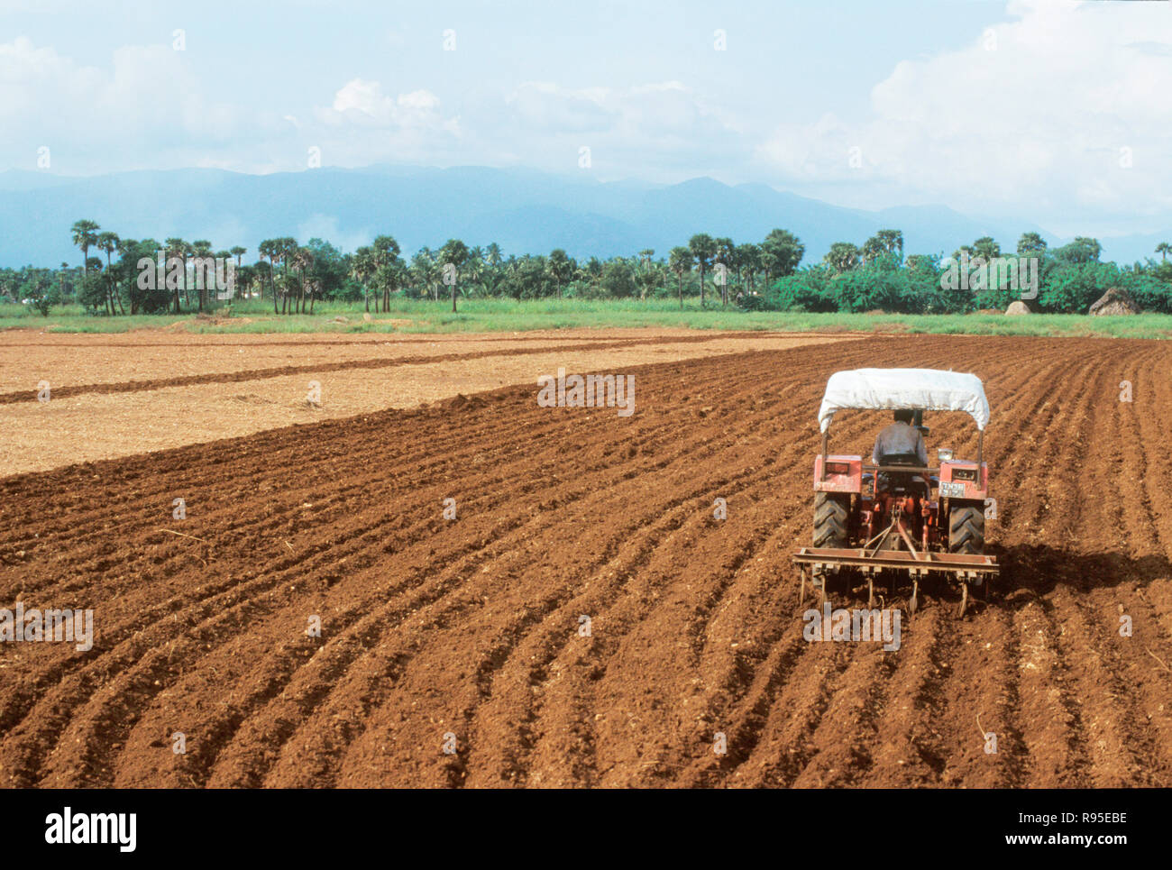 Indian farmer ploughing field tractor hi-res stock photography and ...