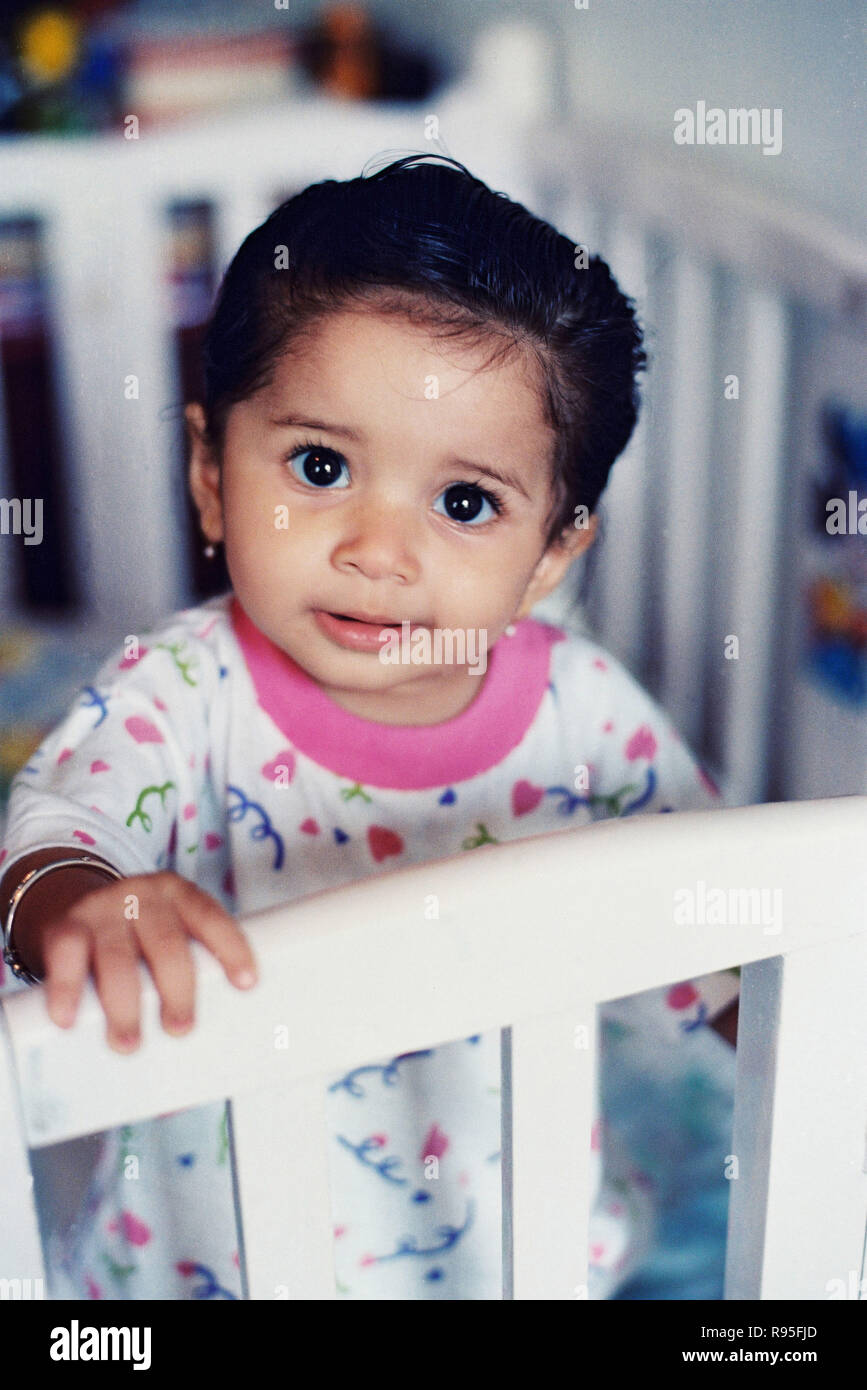 Baby in crib looking at camera Stock Photo Alamy