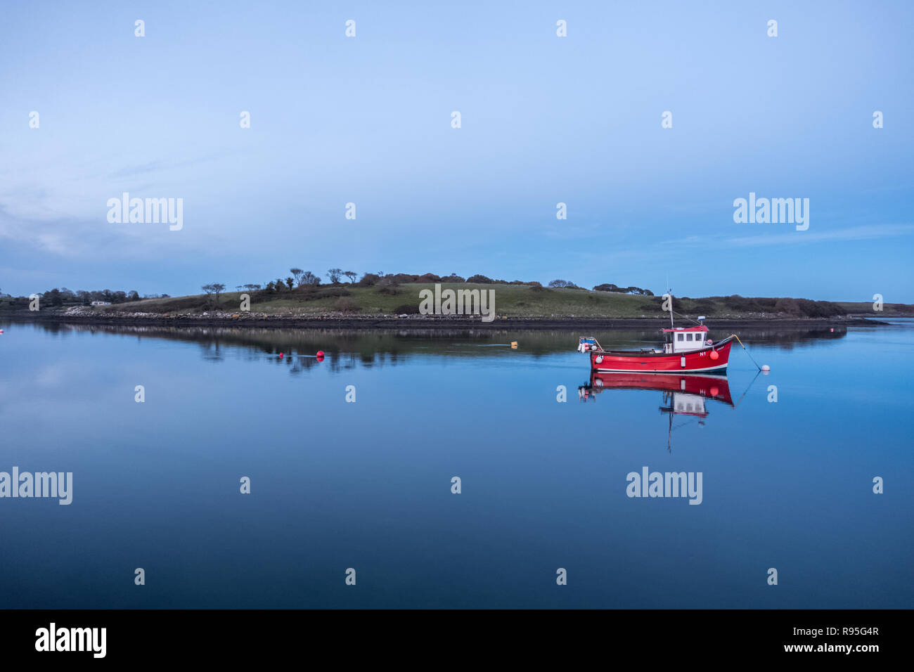 Little red fishing boat reflection Stock Photo