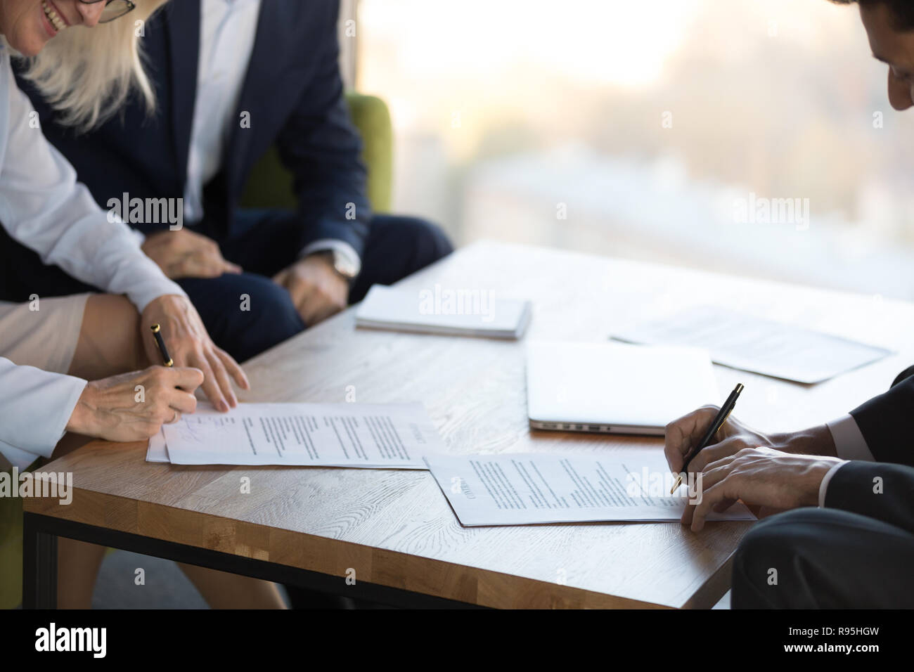 Mature businesswoman and businessman signing contract after nego Stock Photo