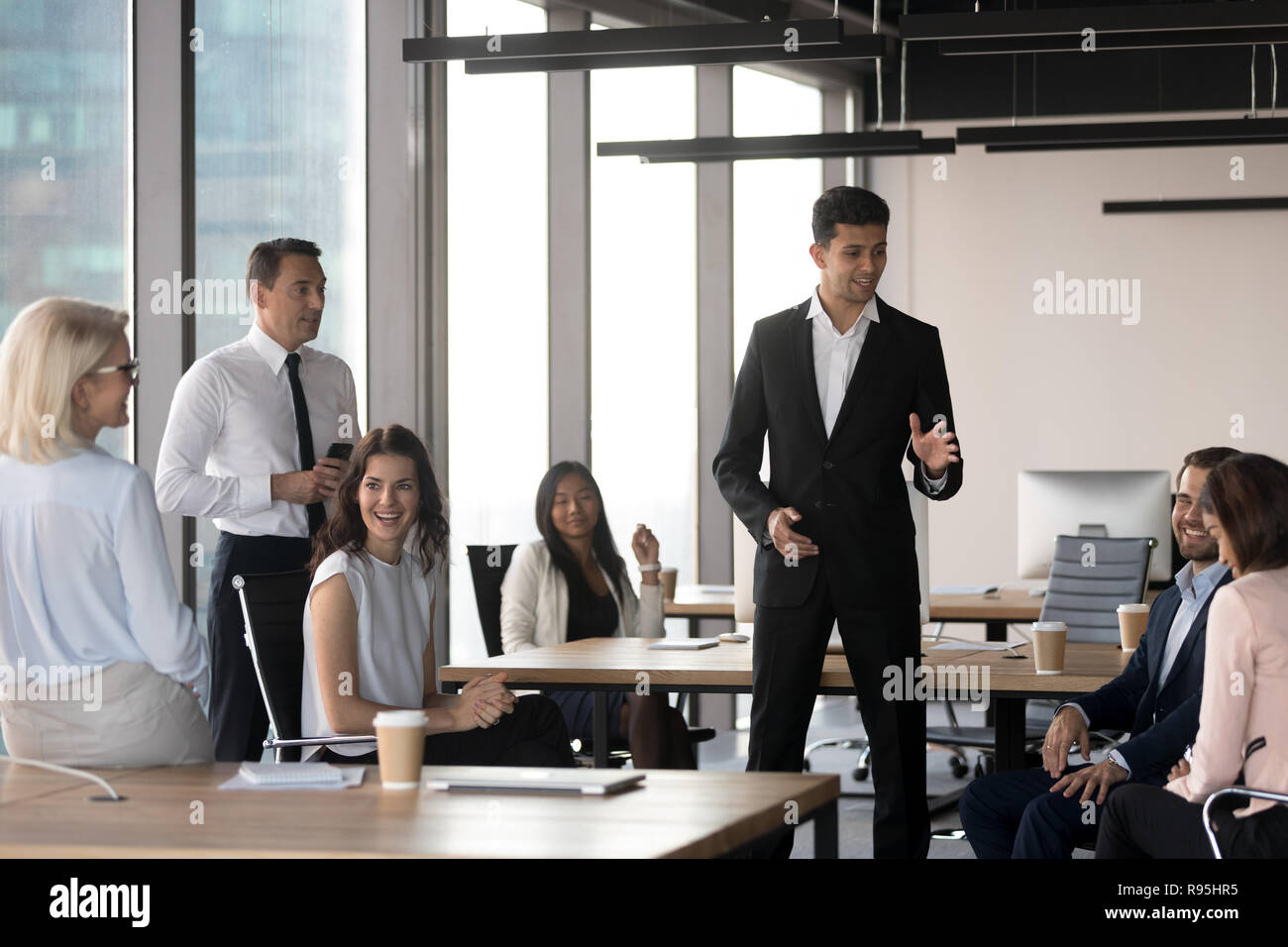 Middle eastern ethnicity team leader representing new project to Stock Photo