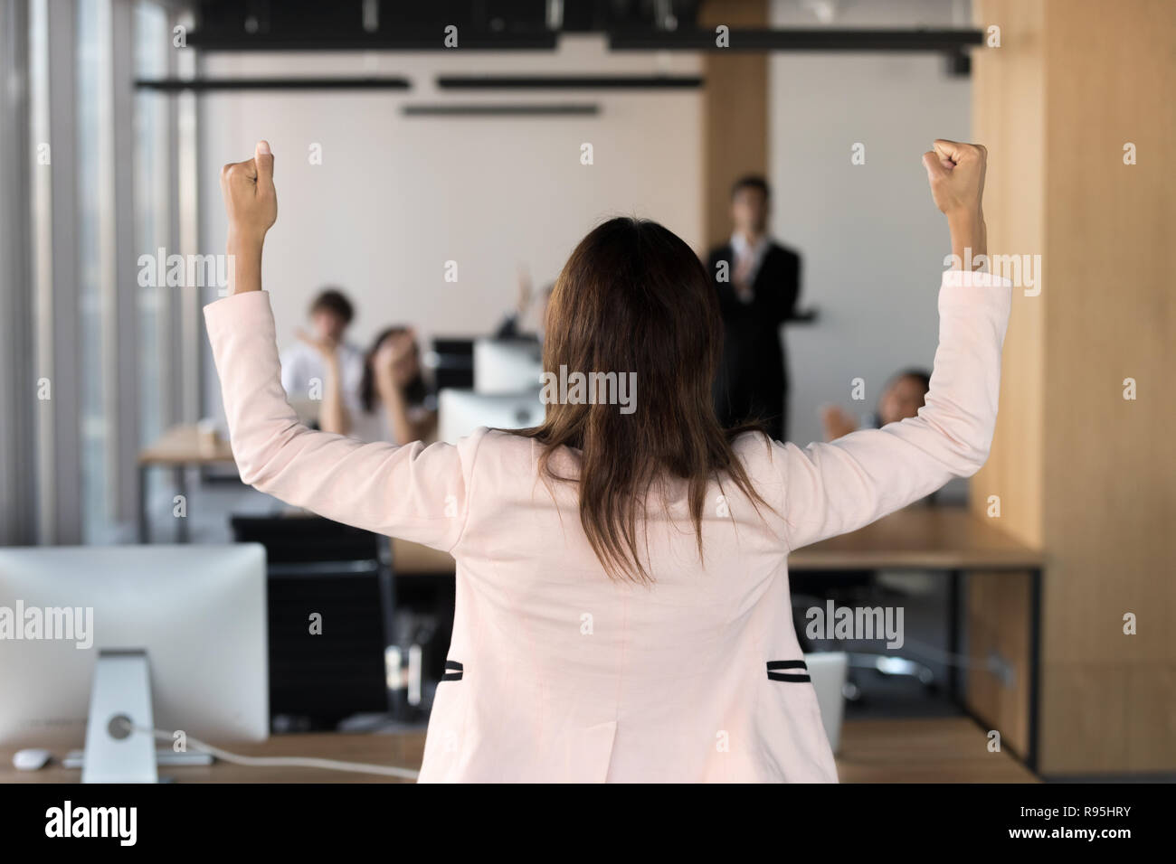 Rear view african team leader raising hands celebrating victory  Stock Photo