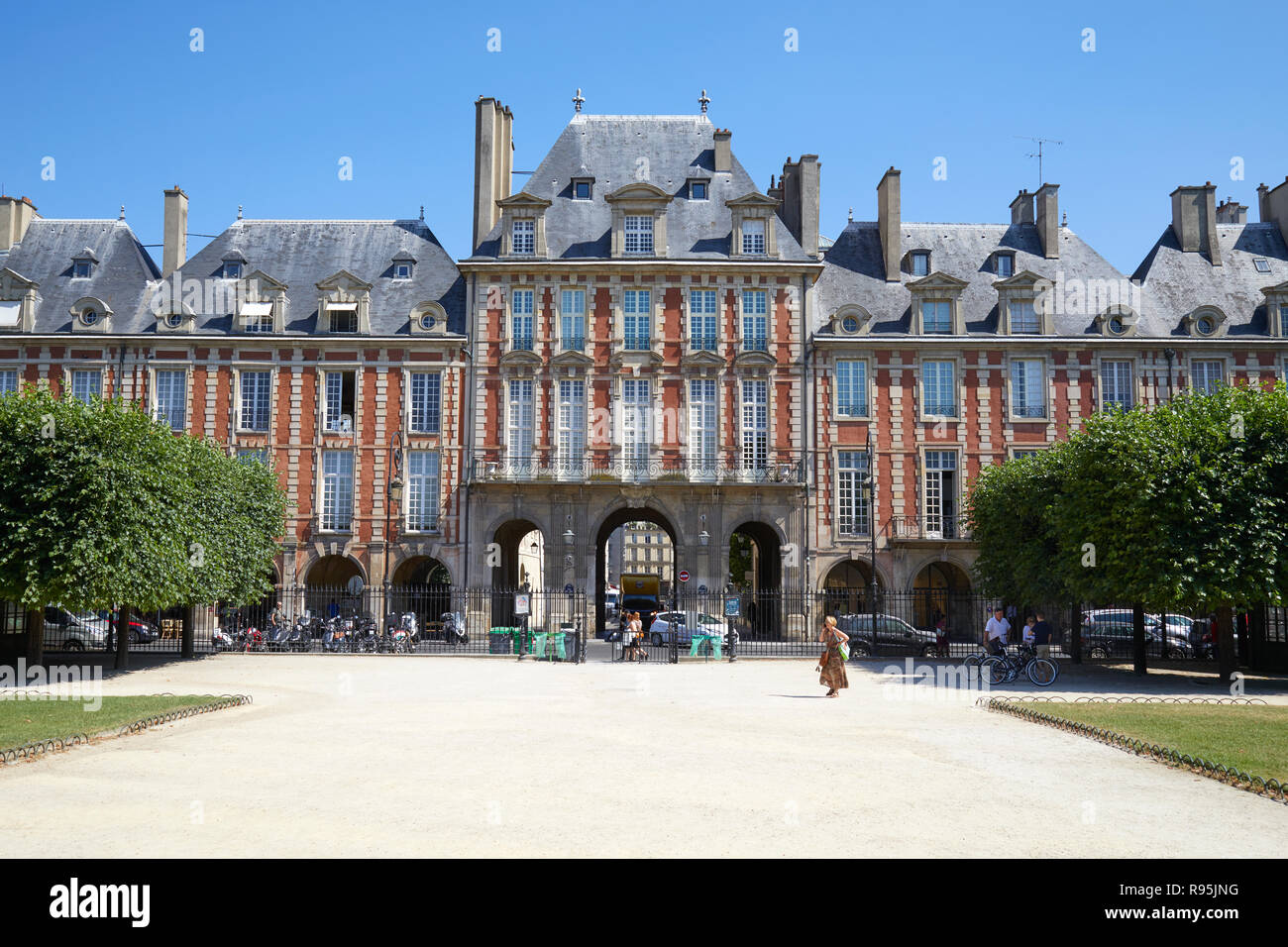 PARIS, FRANCE - JULY 6, 2018: Place des Vosges with ancient buildings and some people at midday in a sunny summer day, clear blue sky in Paris Stock Photo